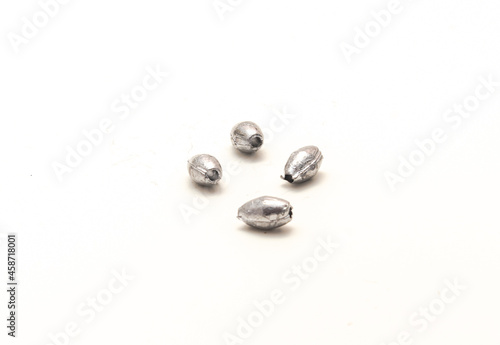 Four silver egg sinkers fishing tackle for Carolina rigging casting isolated on white