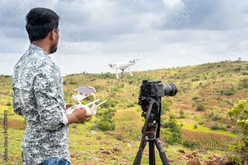 Photography Focus on drone, Young videographer filming video by controlling drone using remo