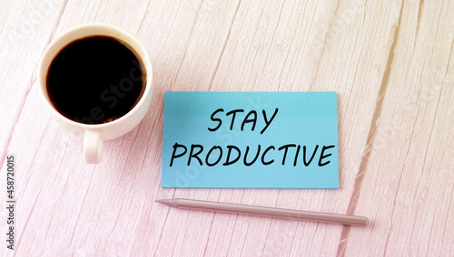 STAY PRODUCTIVE text on the blue sticker with cofee and pen