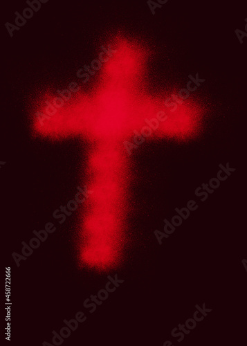 Czerwony, rozmyty krzyż na ciemnym tle.