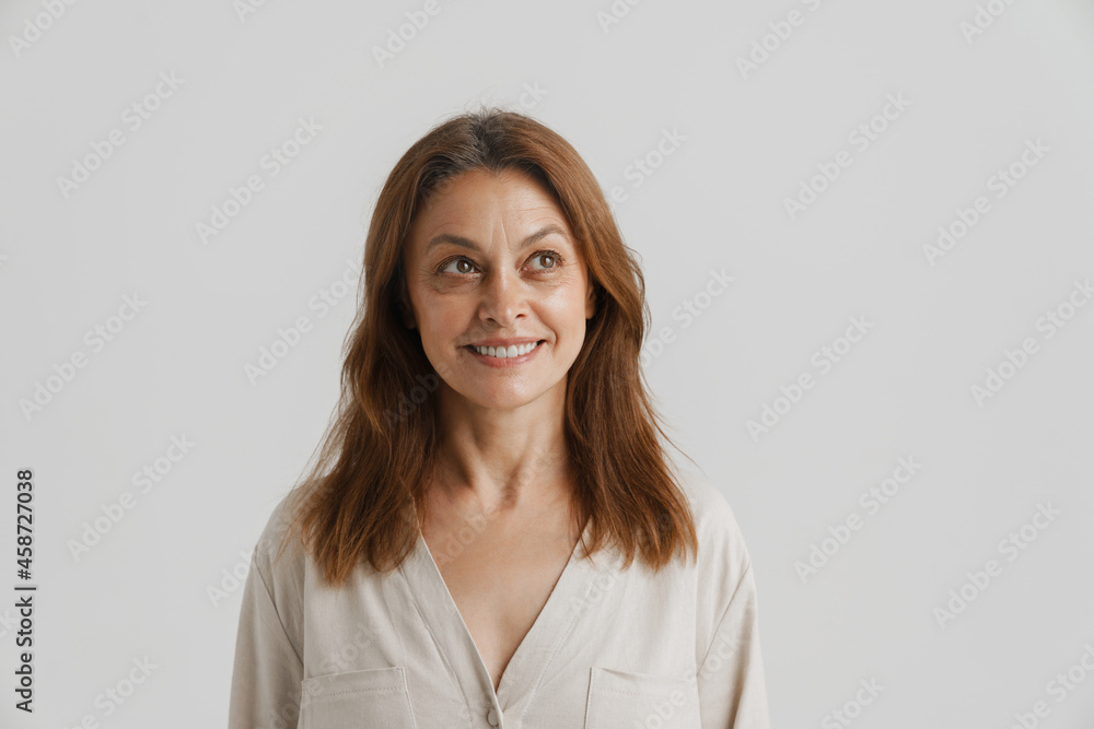 European ginger woman smiling and looking aside European ginger woman smiling and looking aside