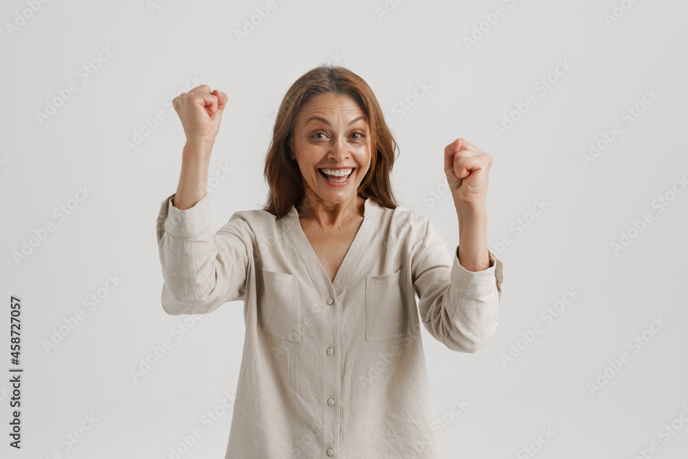 European ginger woman screaming while making winner gesture European ginger woman screaming while making winner gesture