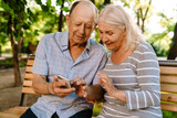 Happy senior couple with smartphones