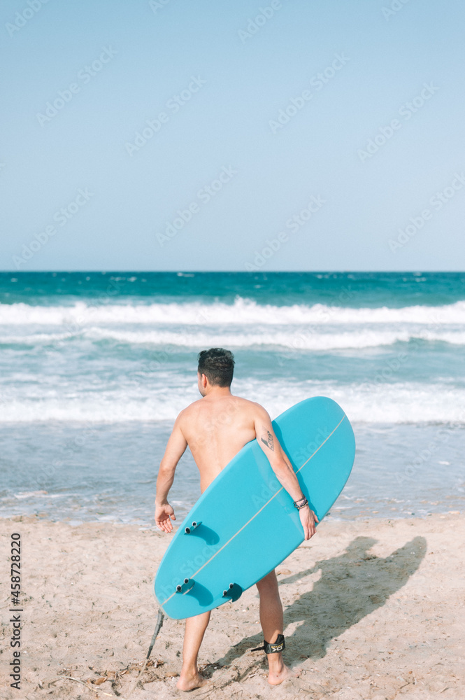 Happy fit young having fun surfing at beach - Sporty man training with surfboard on vacation - Adult healthy people lifestyle and extreme sport concept Happy fit young having fun surfing at beach - Sporty man training with surfboard on vacation - Adult healthy people lifestyle and extreme sport concept