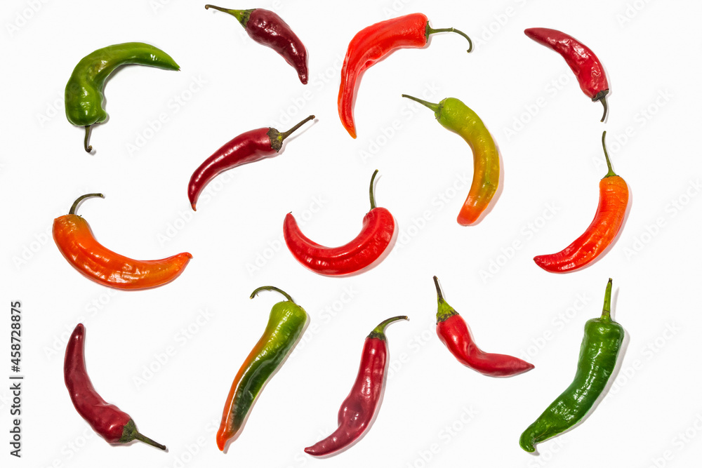 Pattern from multicolored chili peppers on a white background. Isolated Pattern from multicolored chili peppers on a white background. Isolated