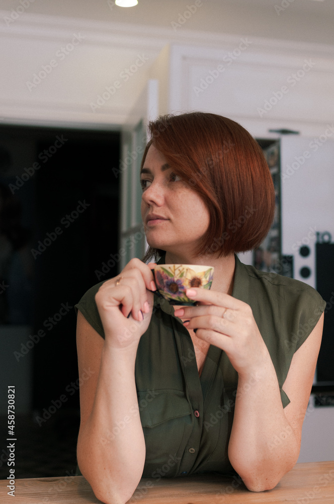 Portrait of a woman at home with a cup in her hands Portrait of a woman at home with a cup in her hands