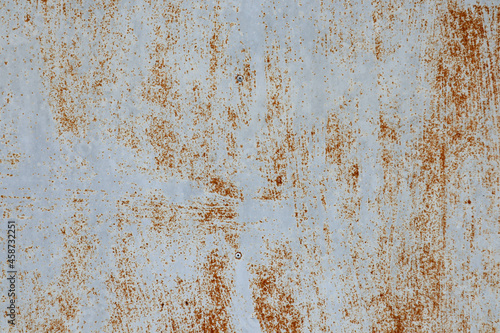 The White metal sheet surface has rust stains dark orange and Brown Color.