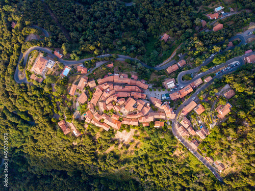Aerial Drone Panorama of mountain old town Marciana on the islands of Elba Italy with green trees and the mediterranean sea ocean in the background photo