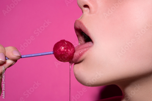 Canvas Print Close up profile, model licking a red lollipop