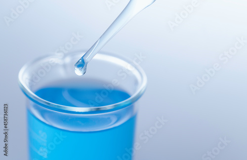 Obraz na płótnie Blue science glass tube experiment on table science copy space.
