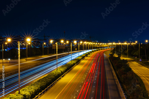 Car light trail on the road at night. Long exposure shot of city light trails captured from Meydan Bridge in Dubai United Arab Emirates.