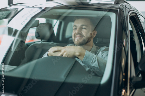 Young business man sitting in a car