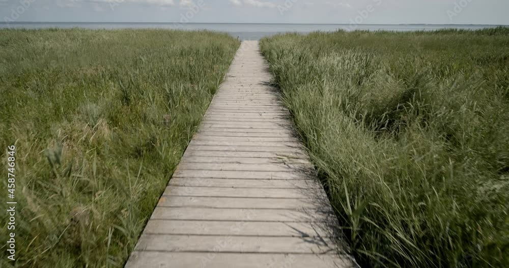 Smooth gimbal shot over a wooden pier on the east side of Sylt with the North Sea in the background Smooth gimbal shot over a wooden pier on the east side of Sylt with the North Sea in the background