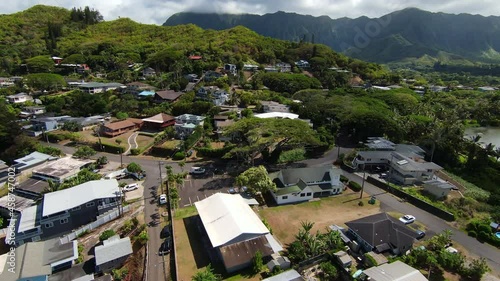 Drone Flying Over Beautiful Kaneohe neighborhood on Oahu in Hawaii, with Mountain Range in the Distance photo