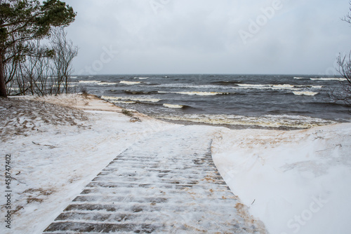 Footpath between winter Baltic Sea s dunes in Saulkrasti in Latvia photo