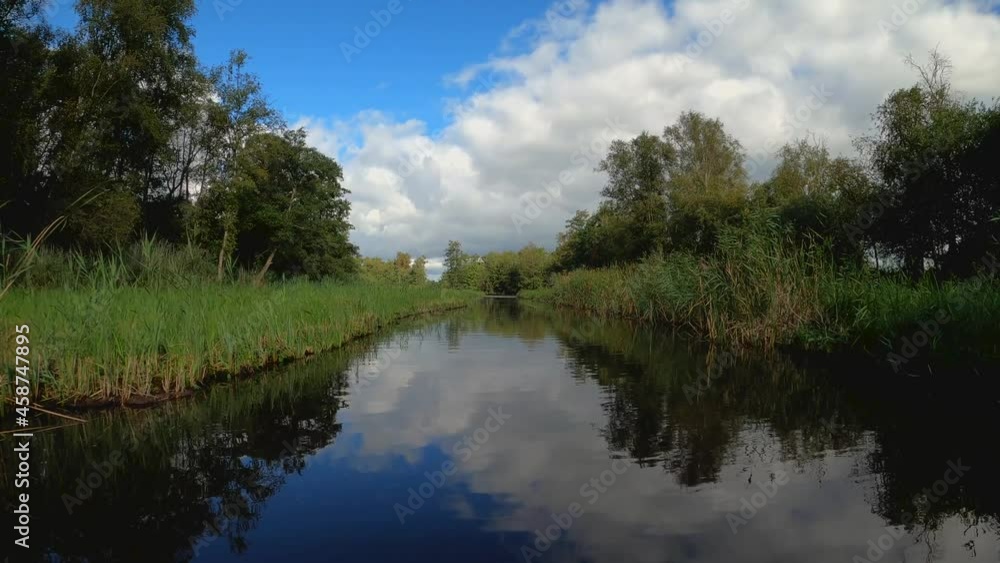 Nature scenery at the Weerribben-Wieden National Park in Overijssel the Netherlands, POV sailing through treed and forest Nature scenery at the Weerribben-Wieden National Park in Overijssel the Netherlands, POV sailing through treed and forest