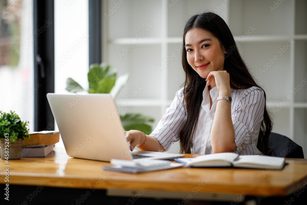 Portrait of a smiling Asian businesswoman in the office. Portrait of a smiling Asian businesswoman in the office.