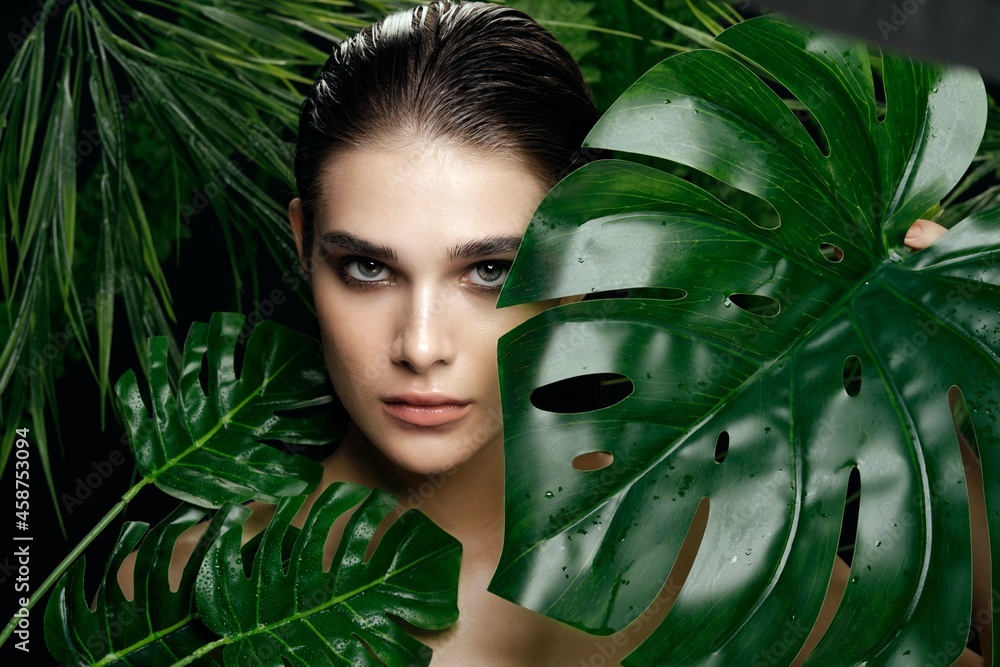 woman near green leaves of palm tree on nature clean skin makeup model woman near green leaves of palm tree on nature clean skin makeup model