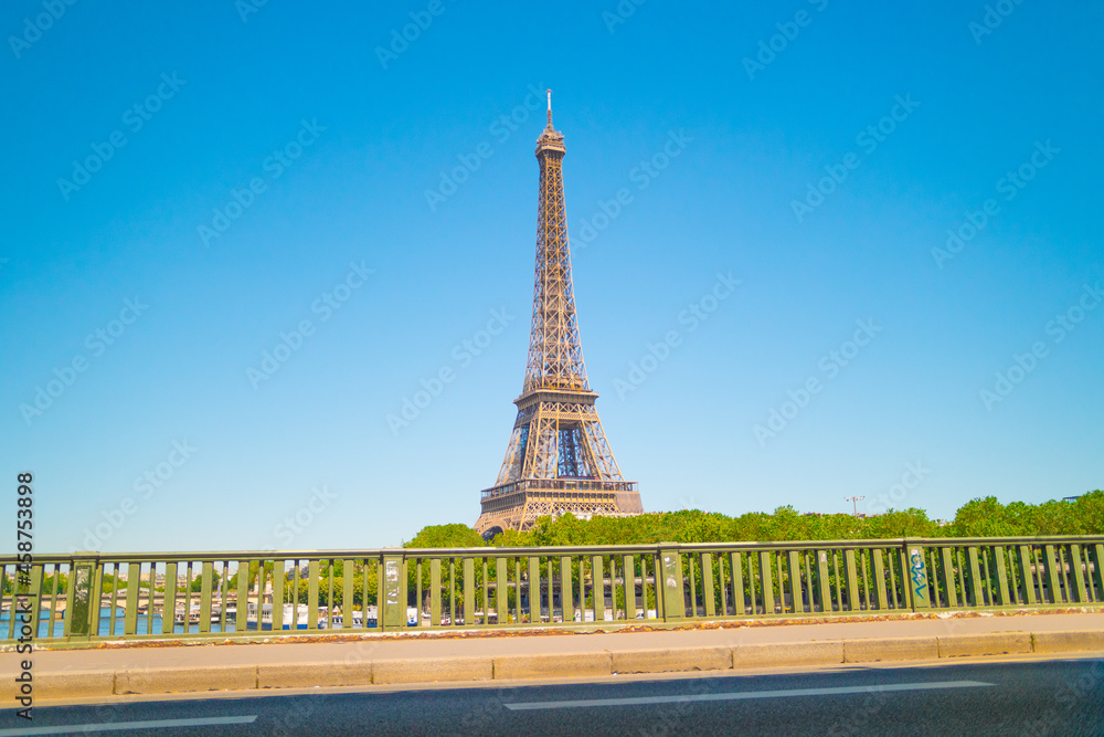 Eiffel tower on a sunny day with blue sky.
