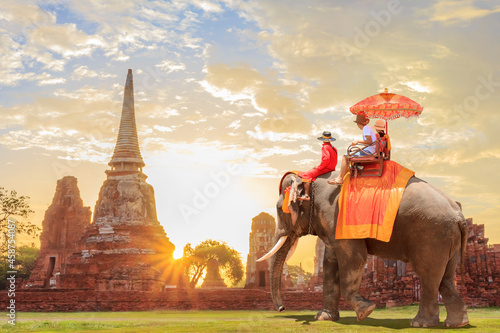 Fotografie, Obraz Tourists on an ride elephant tour of the ancient city in sunrise background