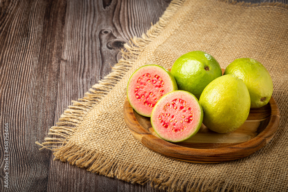 Fresh sliced ​​guavas on wooden table.