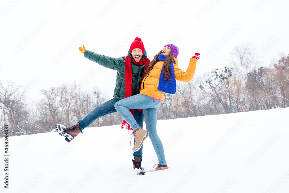 Full size photo of young cheerful couple happy positive smile have fun winter holiday vacation walk park Full size photo of young cheerful couple happy positive smile have fun winter holiday vacation walk park