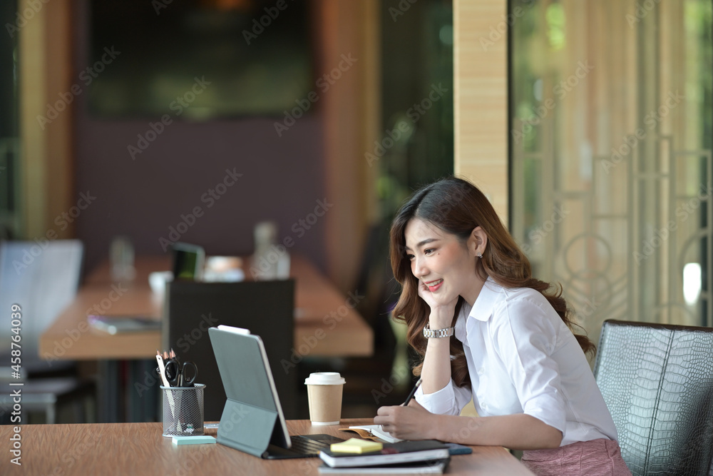 © saltdium - Portrait of beautiful office woman taking notes while keeping a hand on the chin over a comfortable meeting room as a background. © saltdium - Portrait of beautiful office woman taking notes while keeping a hand on the chin over a comfortable meeting room as a background.