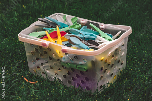 Laundry clips in a basket on the grass