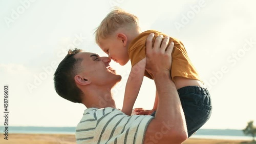 Close-up view of a happy father with his son rubbing noses in nature photo