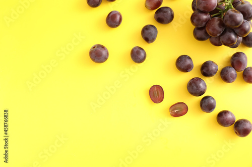 Red grapes isolated top view in yellow background