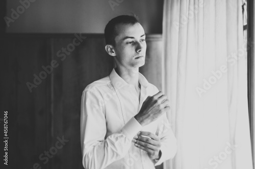 Grooms morning preparation. Handsome man getting dressed and preparing for the wedding photo