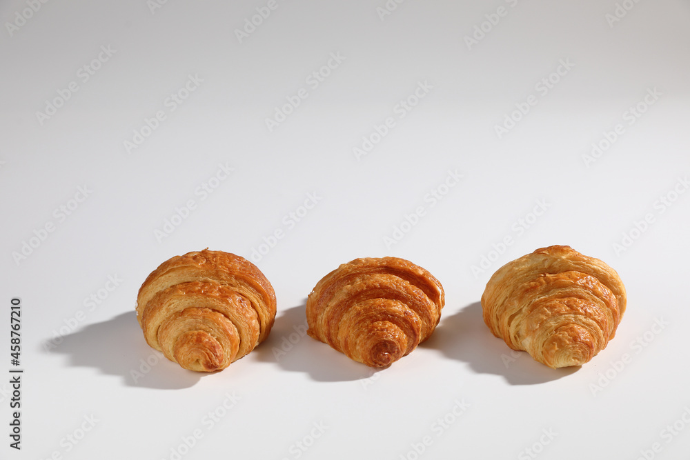 Croissant isolated in  wihite background with sunny light