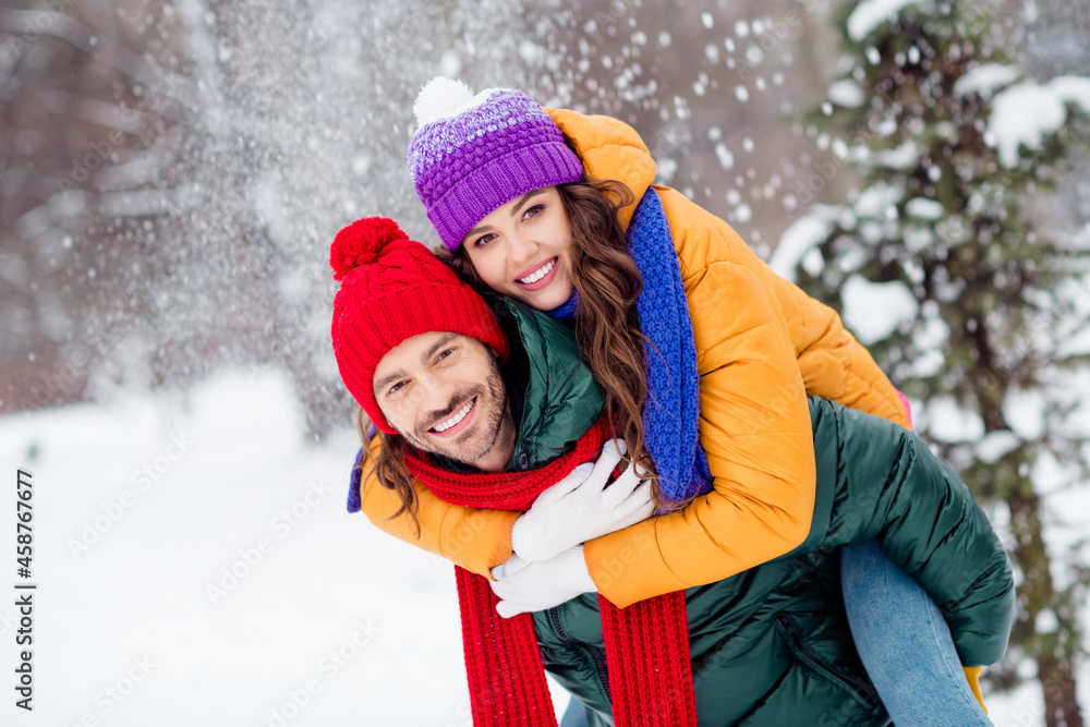 Obraz premium Photo of sweet cute marriage couple wear windbreakers hugging smiling having fun walking snowy weather outside park