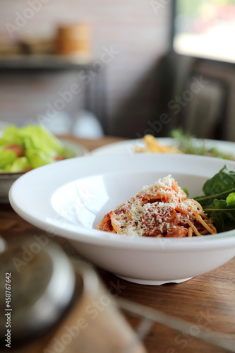 spaghetti Bolognese with italian sausage and tomato sauce with parmesan cheese and basil