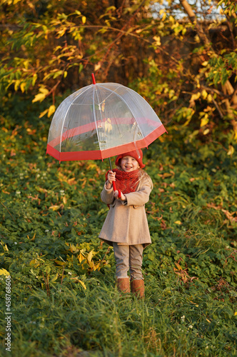 little girl playing with transparent umbrella