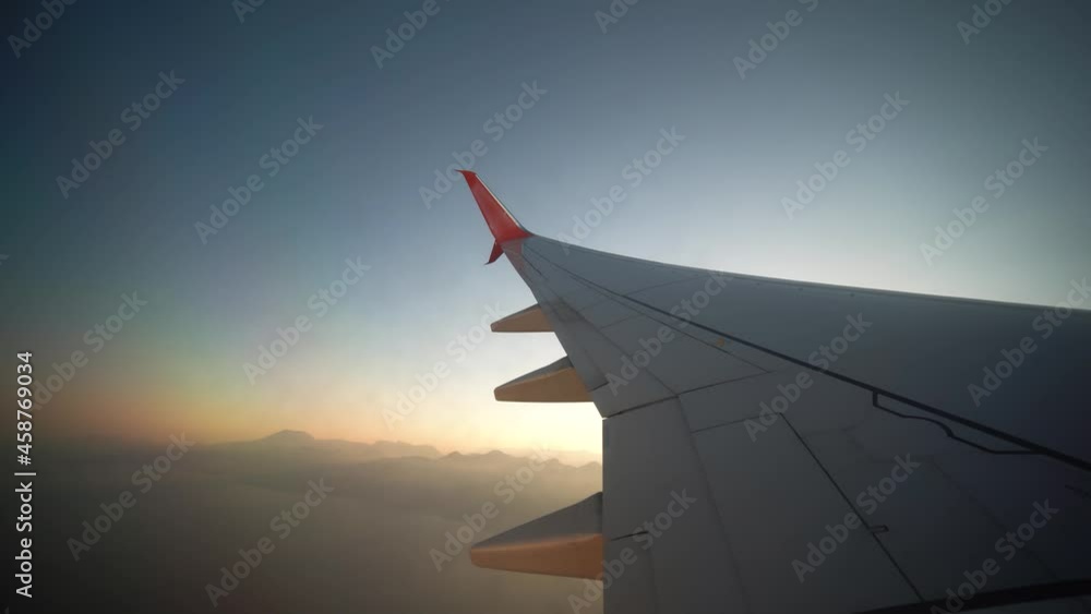 View of the wing of the plane through the window, sunset, clouds. Flight and tourism concept. Turkey View of the wing of the plane through the window, sunset, clouds. Flight and tourism concept. Turkey