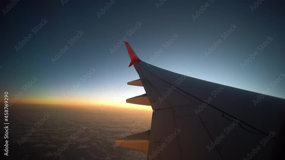 View of the wing of the plane through the window, sunset, clouds. Flight and tourism concept. Turkey View of the wing of the plane through the window, sunset, clouds. Flight and tourism concept. Turkey