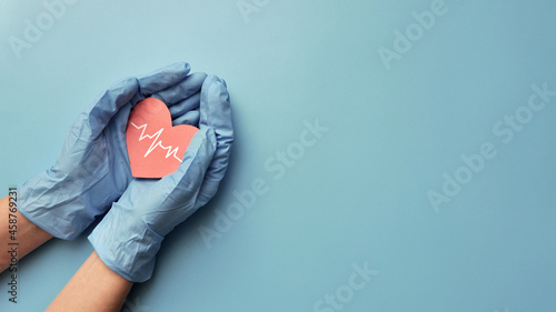 hearts with a cardiogram in the hands of a doctor. A symbol of protection and prevention from heart diseases
