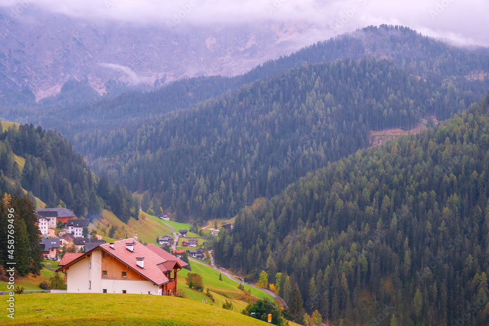 Cozy little village near the church of Santa Barbara on a foggy morning, La Valle, Alta Badia, South Tyrol
