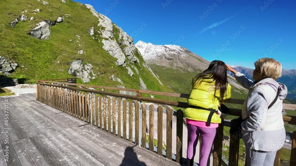 Happy family looking at wonderful alpin landscape in summer season