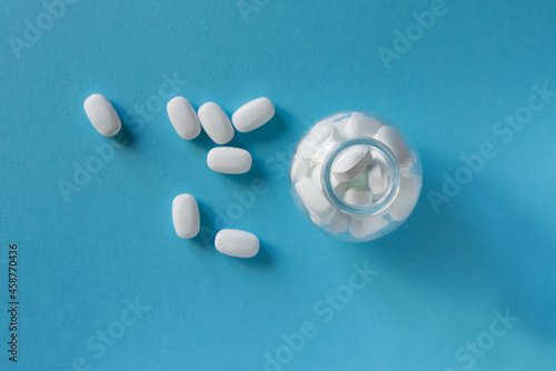 White pills on blue background	
