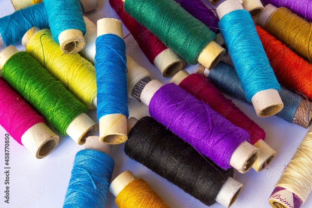 multicolour sewing thread bobbin on white background multicolour sewing thread bobbin on white background