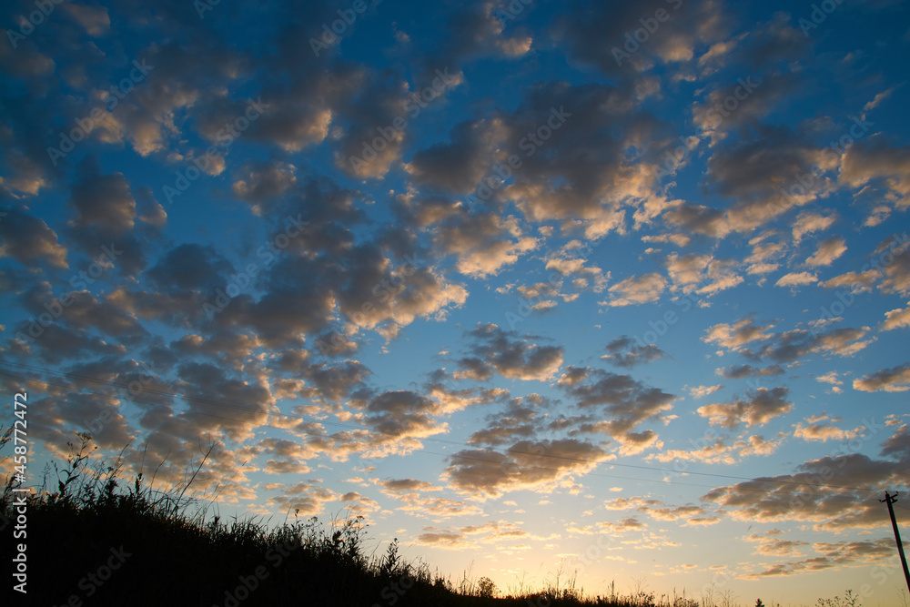 beautiful blue sky with small clouds at sunset beautiful blue sky with small clouds at sunset