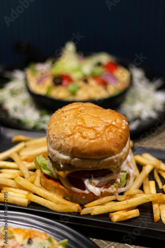 hamburger and fries in black plate