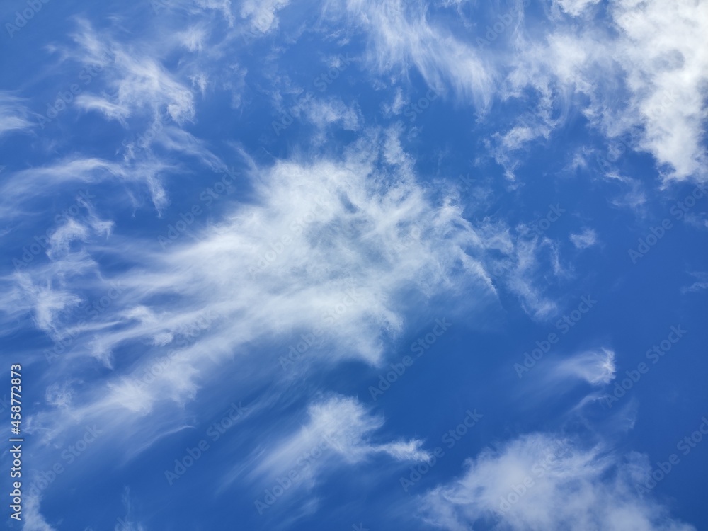 Cirrus clouds rush, driven by the wind, smearing across the sky Cirrus clouds rush, driven by the wind, smearing across the sky