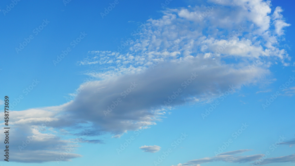 Large cloud angling against blue sky suitable for background or sky substitution Large cloud angling against blue sky suitable for background or sky substitution
