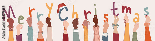 Raised arms of colleagues or friends diverse and multi-ethnic people holding letters forming the text -Merry Christmas- Banner happy Christmas holidays wishes. Racial equality. Community