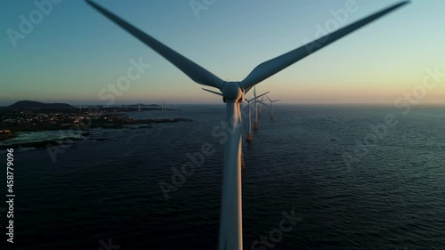 Beautiful sunset background the wind power generators on the sea, Offshore wind turbine in Jeju Island. South Korea. 제주 해안 풍력발전 photo