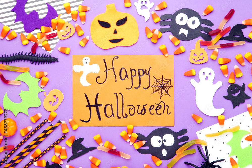 Text Happy Halloween with candies, paper pumpkins, bats, ghosts and straws on purple background