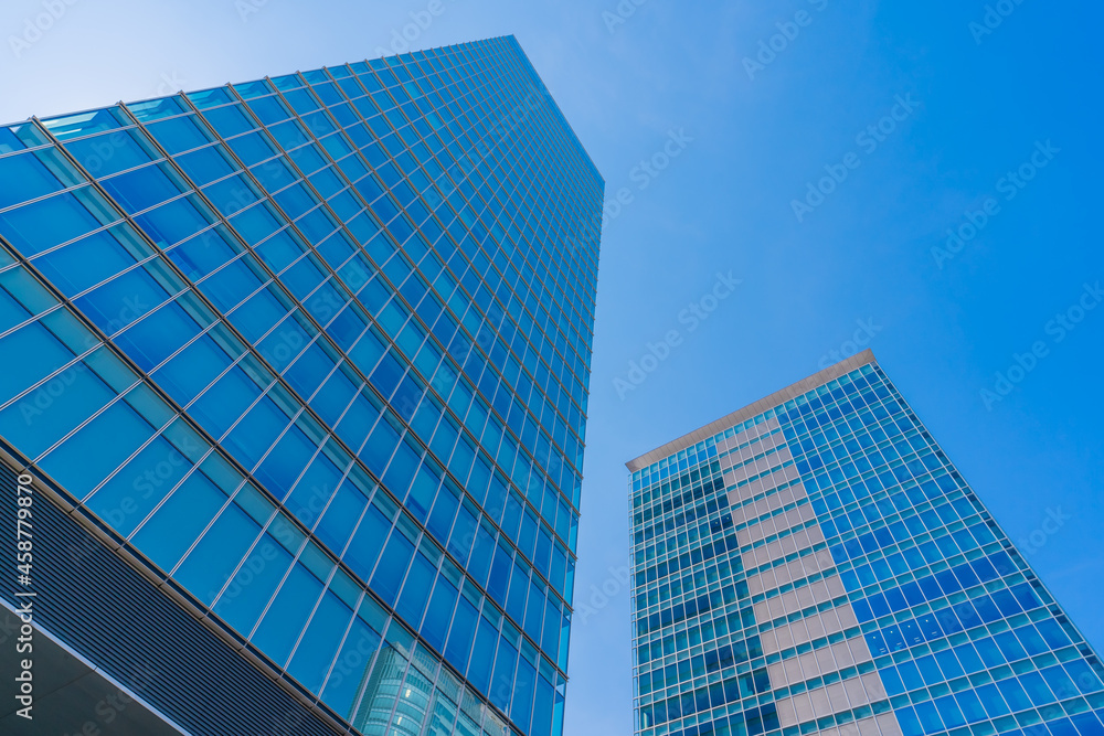 Akihabara, Tokyo, Japan. Modern skyscrapers in the business district against a blue sky. Akihabara, Tokyo, Japan. Modern skyscrapers in the business district against a blue sky.